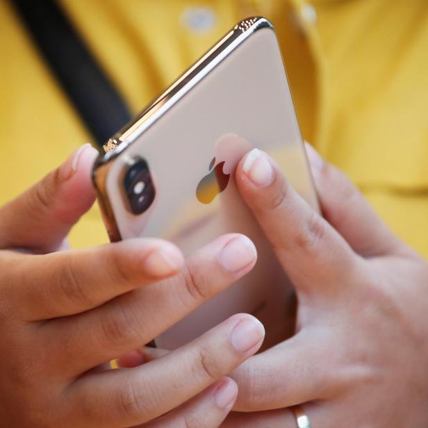 A customer looks at Apple's new iPhone XS after it went on sale at the Apple Store in Tokyo