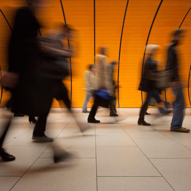 Commuters on modern subway with orange background