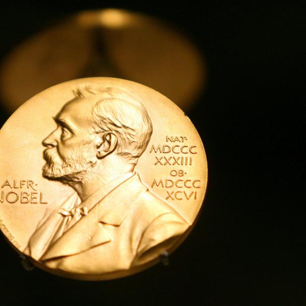 Nahaufnahme einer goldenen Nobelpreis-Medaille mit dem Profil von Alfred Nobel.