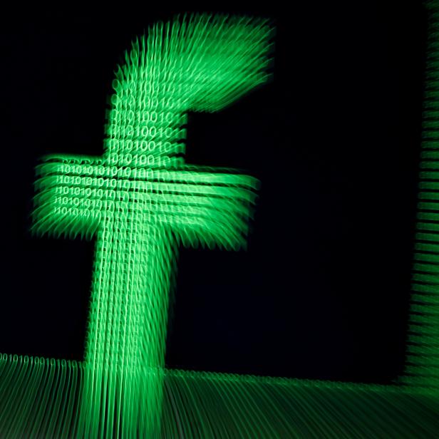 FILE PHOTO: A 3D-printed Facebook logo is seen in front of displayed binary digits in this illustration