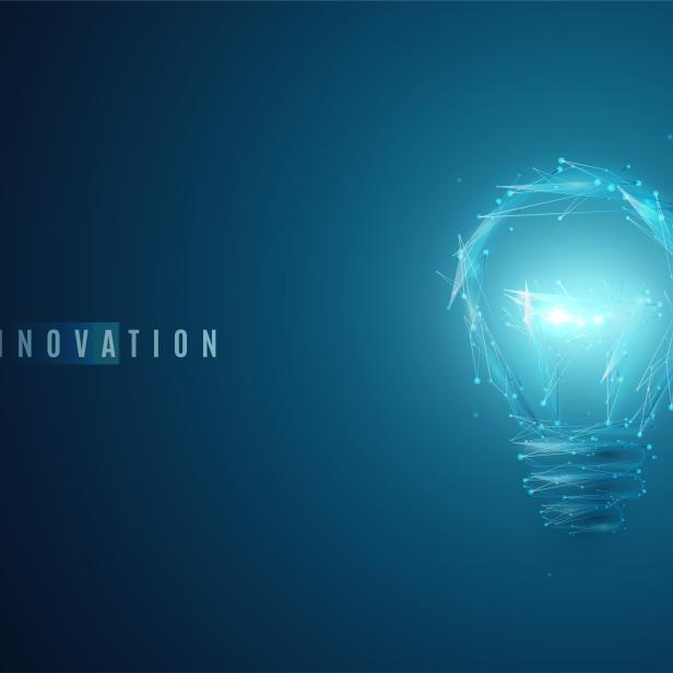 Innovation concept. Lightbulb in modern polygonal style with light effect