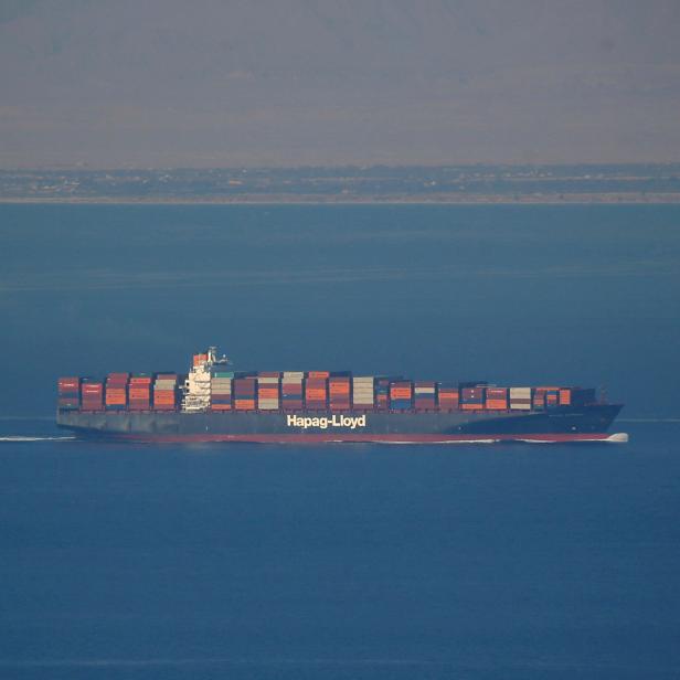 FILE PHOTO: A Hapag Lloyd container ship sails across the Gulf of Suez Canal, in El Ain El Sokhna in Suez, east of Cairo