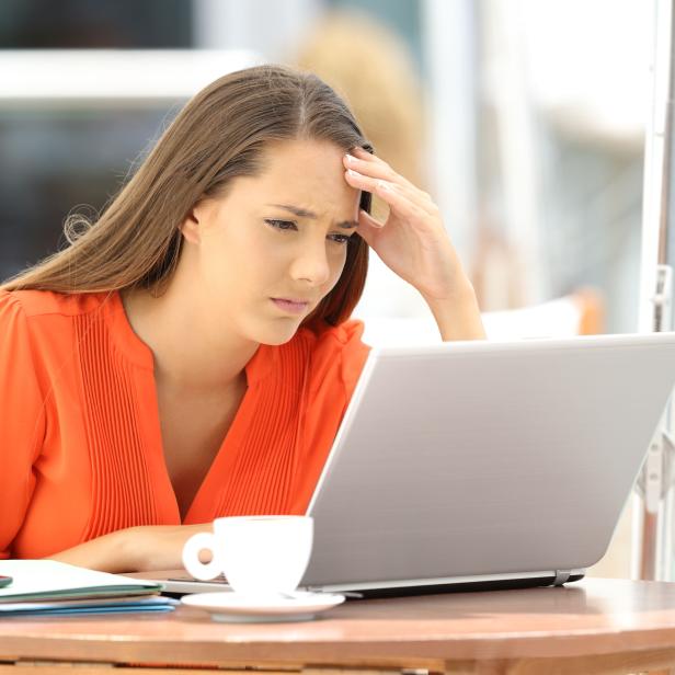 Worried entrepreneur reading bad news on line