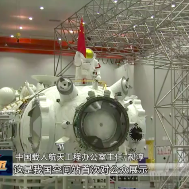 Ein Astronaut steht mit einer chinesischen Flagge auf einem Raumstationsmodul.