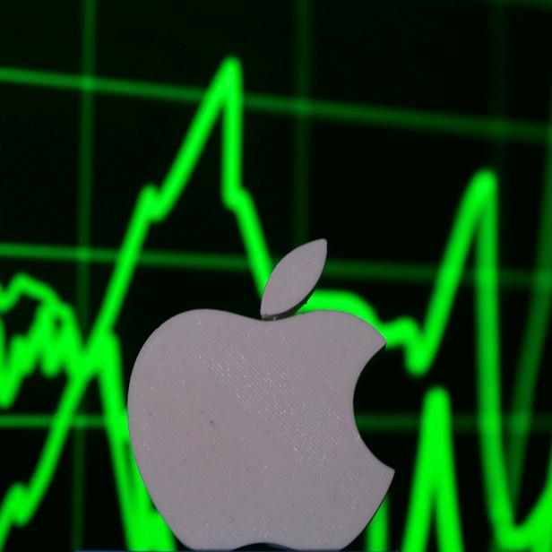 FILE PHOTO: A 3D printed Apple logo is seen in front of a displayed stock graph in this photo illustration