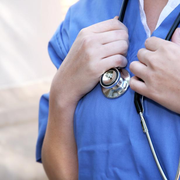 Horizontal Closeup of Doctor Holding Stethoscope