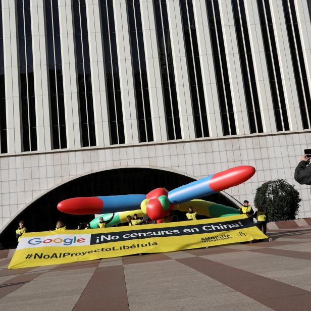 Amnesty International activists hold a banner that reads: "Google, don't censor in China" during a protest against Google's plan to launch a censored search engine in China, outside Google's headquarters in Madrid