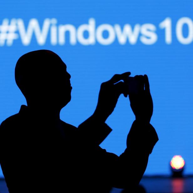 A Microsoft delegate takes a picture during the launch of the Windows 10 operating system in Kenya's capital Nairobi