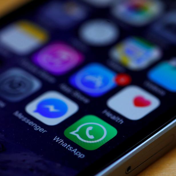 FILE PHOTO: WhatsApp and Facebook messenger icons are seen on an iPhone in Manchester , Britain.