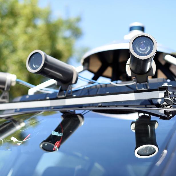 Cameras line the roof of an autonomous Acura's RLX Sport Hybrid SH-AWD during a media tour of carmaker Honda's testing grounds at the GoMentum Station autonomous vehicle test facility in Concord