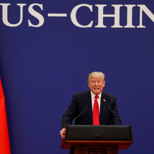 FILE PHOTO: U.S. President Donald Trump delivers his speech as he and China's President Xi Jinping meet business leaders at the Great Hall of the People in Beijing