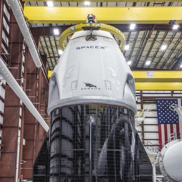 Eine SpaceX Dragon-Kapsel steht in einer Montagehalle.