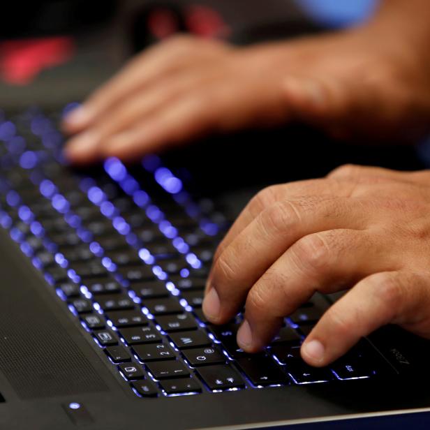 FILE PHOTO: A man types into a keyboard during the Def Con hacker convention in Las Vegas