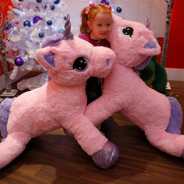 Aston Robertson-Jeyes, aged 3, plays with Unice Unicorn, at the launch of Hamleys top Christmas toys launch in London