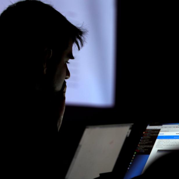 FILE PHOTO: A man takes part in a hacking contest during the Def Con hacker convention in Las Vegas