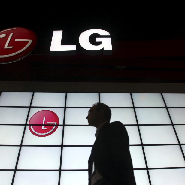 FILE PHOTO: File picture shows a show attendee passing by the LG Electronics booth during the 2009 International Consumer Electronics Show in Las Vegas