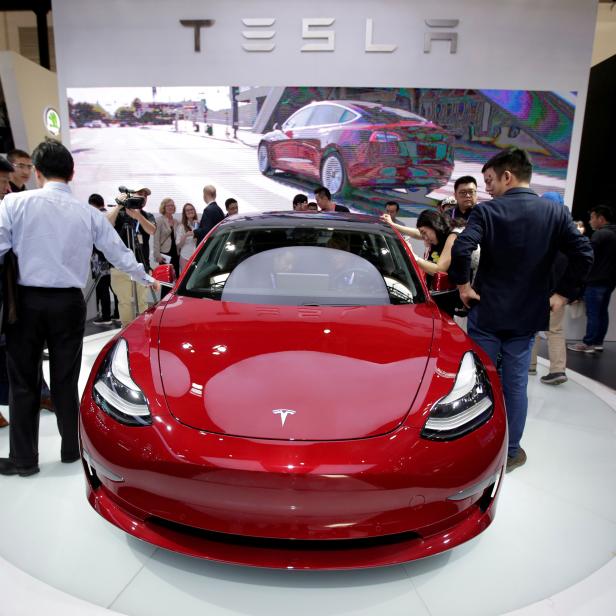 FILE PHOTO: A Tesla Model 3 car is displayed during a media preview at the Auto China 2018 motor show in Beijing