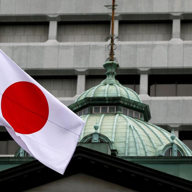 FILE PHOTO: A Japanese flag flutters atop the Bank of Japan building in Tokyo