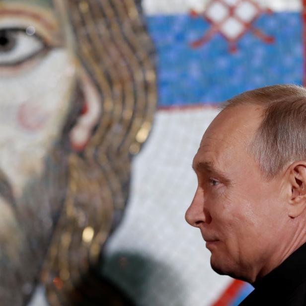 Russian President Vladimir Putin stands during his visit to the St Sava temple in Belgrade