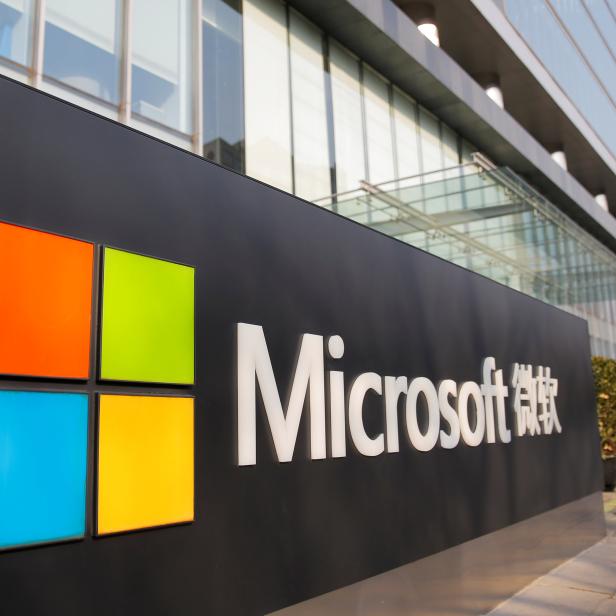 FILE PHOTO: FILE PHOTO: People walk outside the Microsoft office in Beijing