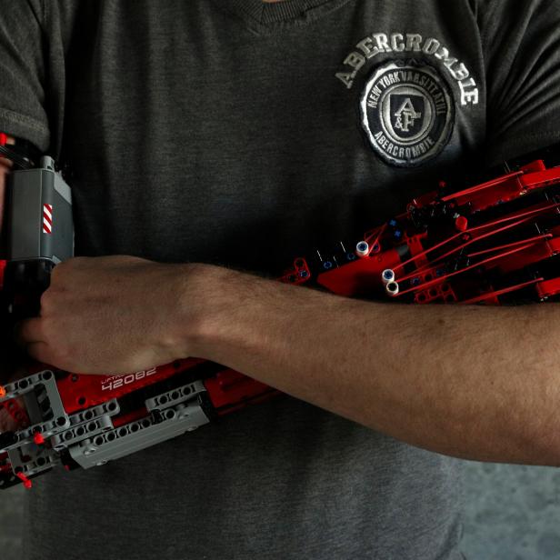 David Aguliar poses with his prosthetic arm built with Lego pieces during an interview with Reuters in Sant Cugat del Valles