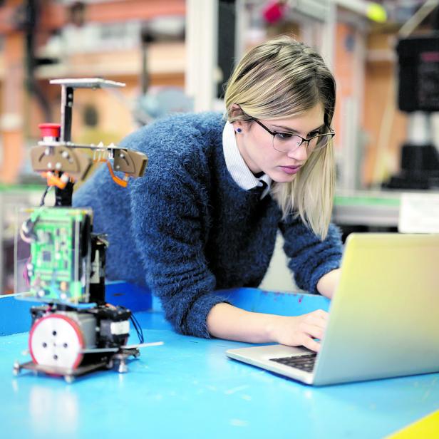 Young woman engineer working on robotics project