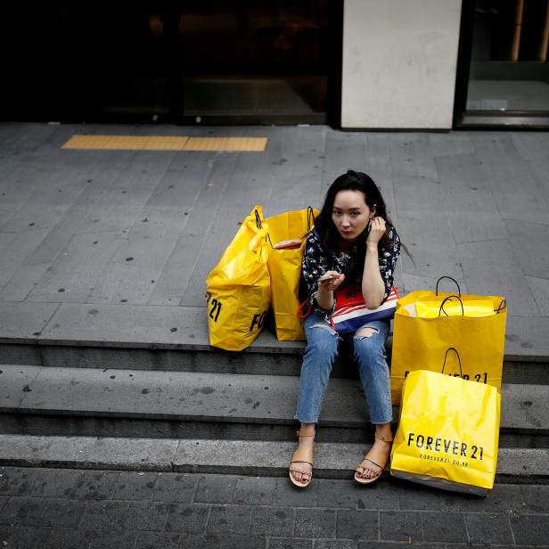 FILE PHOTO: A woman uses her mobile phone at Myeongdong shopping district in Seoul