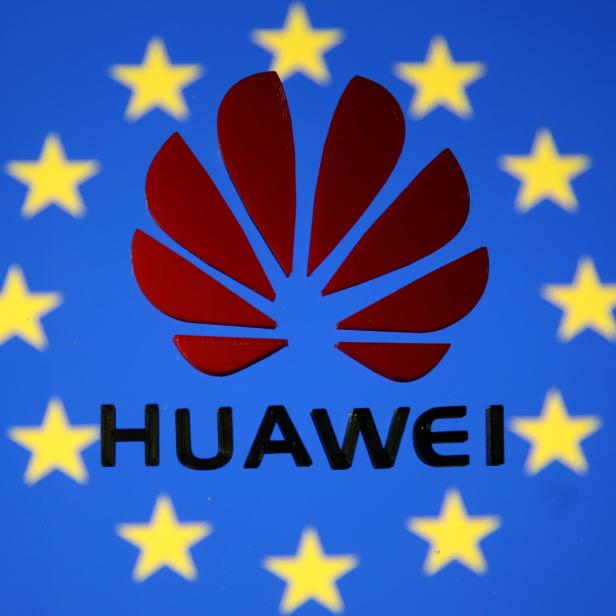 A 3D printed Huawei logo is placed on glass above displayed EU flag in this illustration taken