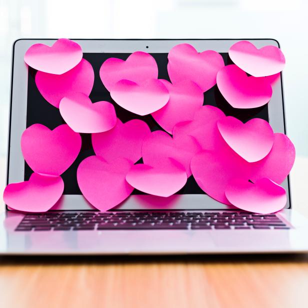 Laptop screen covered by heart shape adhesive notes