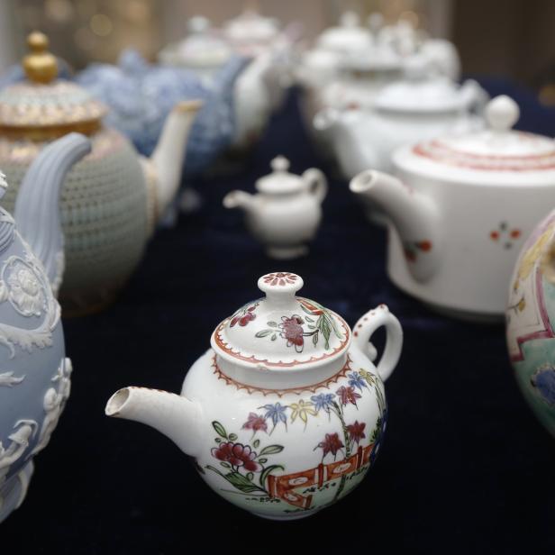 A rare Vauxhall minitature polychrome teapot (dated c.1760) is pictured with some of the Hanley Collection of Teapots at Sotheby's auction house in London