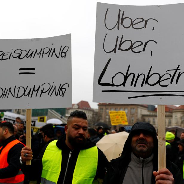 Licensed taxi drivers protest against a planned change of the passenger transport law in front of the Federal Department of Transportation in Berlin