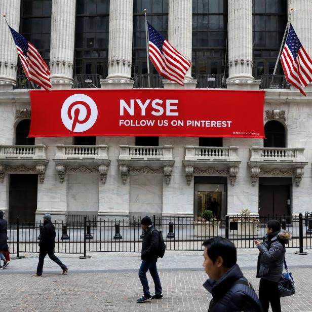 A Pinterest banner hangs on the facade of the New York Stock Exchange, (NYSE) during the morning rush in the financial district in New York