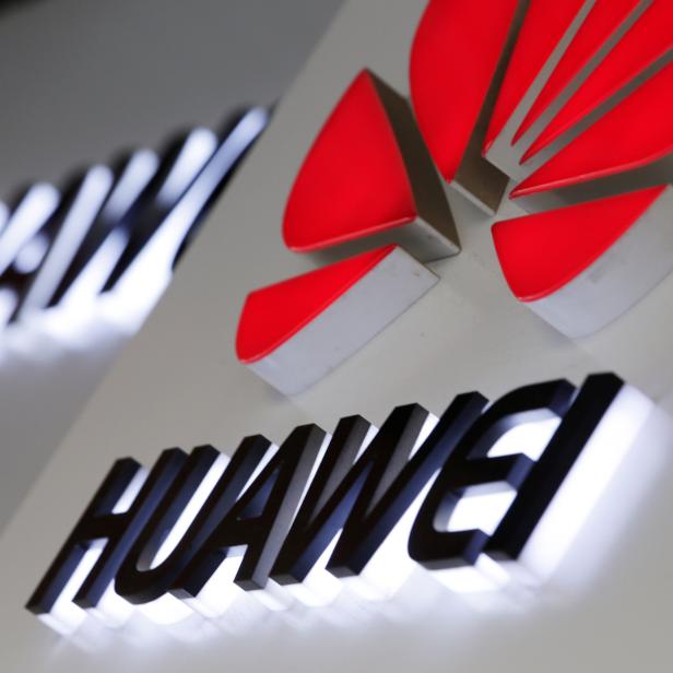 Logos of Huawei are pictured outside its shop in Beijing