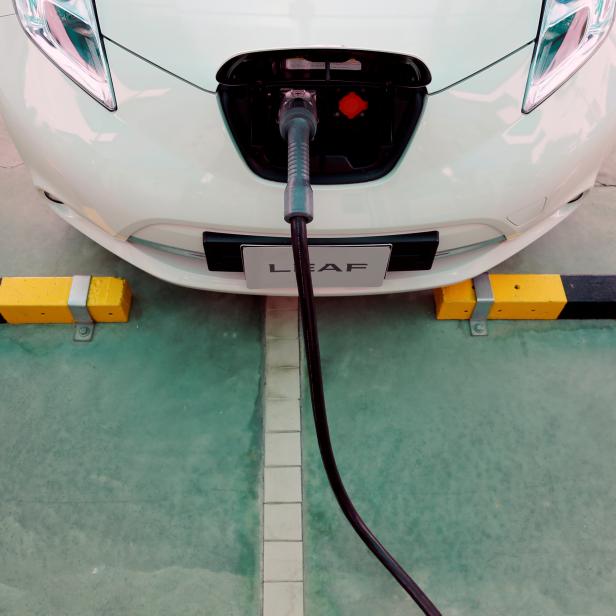 FILE PHOTO: An electric car is seen while being charged during the opening of a PTT Pcl energy firm's commercial EV charging station, in Bangkok