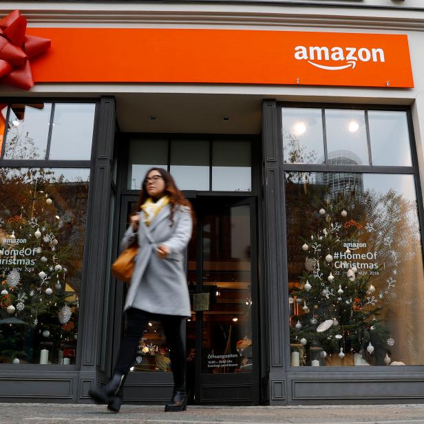 A customer leaves a new Amazon pop-up store for Christmas at Berlin's main shopping street Kurfurstendamm boulevard in Berlin