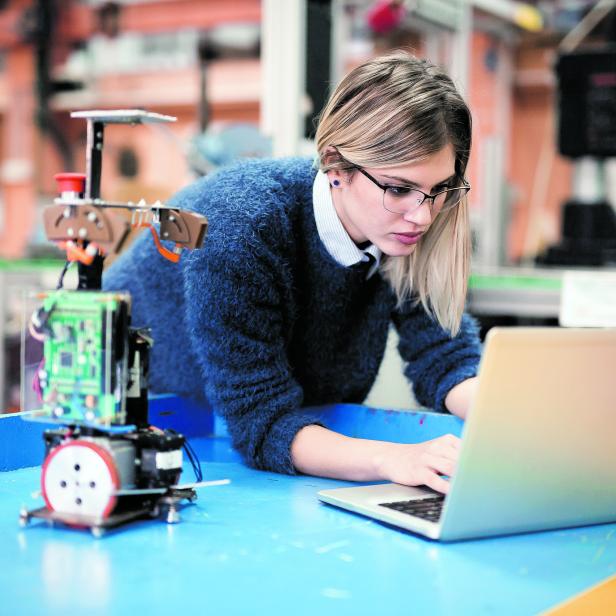 Young woman engineer working on robotics project