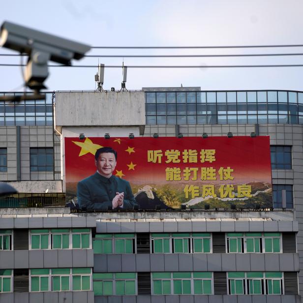 FILE PHOTO: Poster with a portrait of Chinese President Xi is displayed in Shanghai