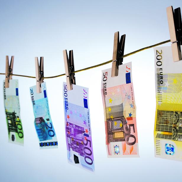 Euro cash notes hanging from a clothesline