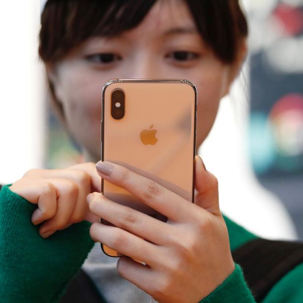 A customer looks at Apple's new iPhone XS after it went on sale at the Apple Store in Tokyo