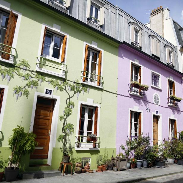 A view shows rue Cremieux, a street lined with colorful, terraced homes, and a hostel "L'Hotel Particulier" located in the 12th district of Paris