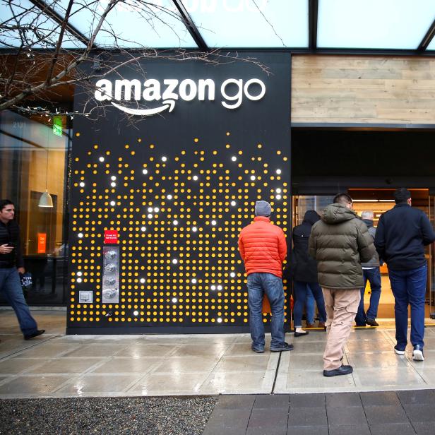 FILE PHOTO:    People are offered free reusable bags as they enter the new Amazon Go store in Seattle