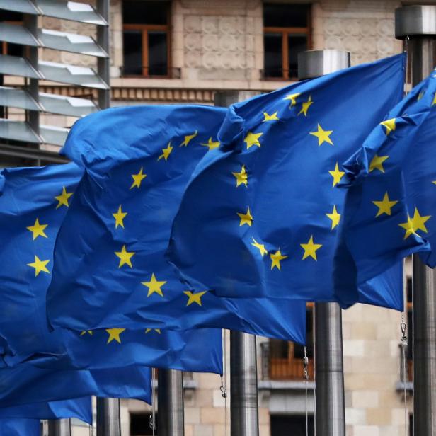 EU flags fly outside the European Commission headquarters in Brussels