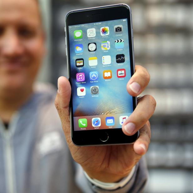 A customer shows a newly purchased iPhone 6S Plus at the Apple Retail in Palo Alto