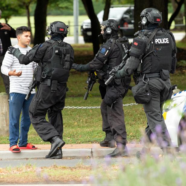 AOS (Armed Offenders Squad) push back members of the public following a shooting at the Masjid Al Noor mosque in Christchurch