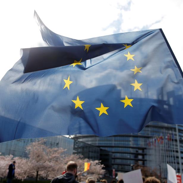 A demonstrator holds an European flag as he takes part in a protest in front of the European Parliament as MEPs debate on modifications to EU copyright reforms in Strasbourg