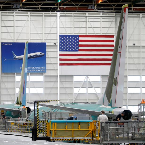 Employees work on 737 Max aircraft, seen at the Boeing factory in Renton