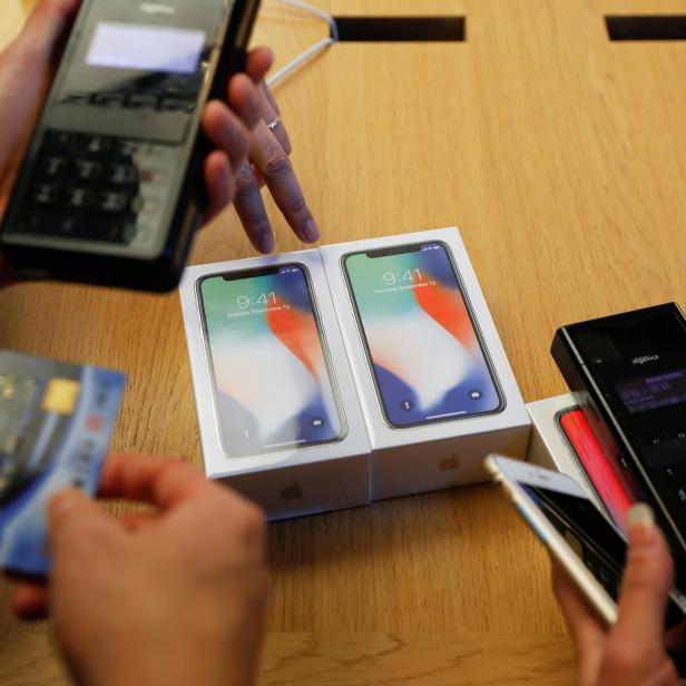 FILE PHOTO: New iPhone X phones are purchased at an Apple Store in Beijing