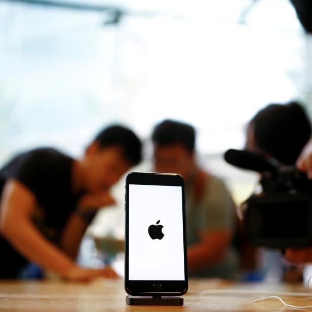 FILE PHOTO: Members of the media film the new iPhone 7 at an Apple store in Beijing