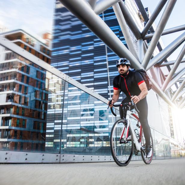 Commuter cycling fast at work in the morning