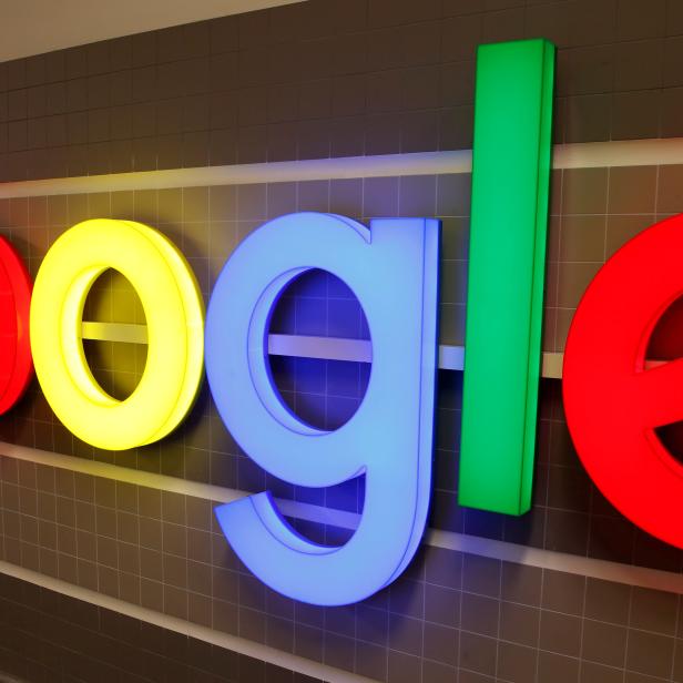 FILE PHOTO: An illuminated Google logo is seen inside an office building in Zurich